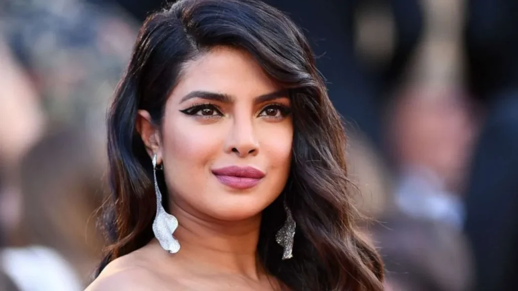 Actress Priyanka Chopra Jonas speaking passionately into a microphone during a high-profile media interview.