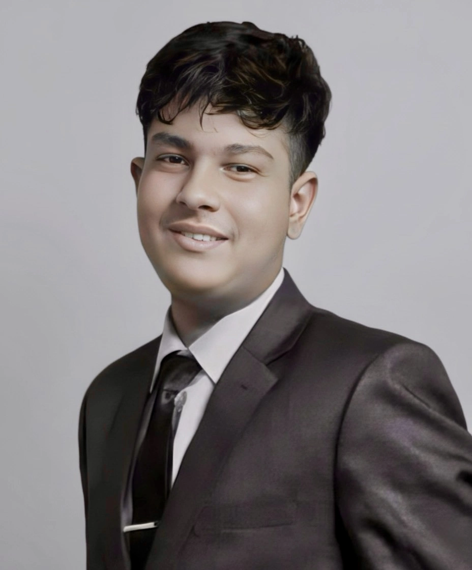 Portrait of Adarsha Dhakal, founder and editor of Investozora, wearing a dark suit and tie against a light gray background.